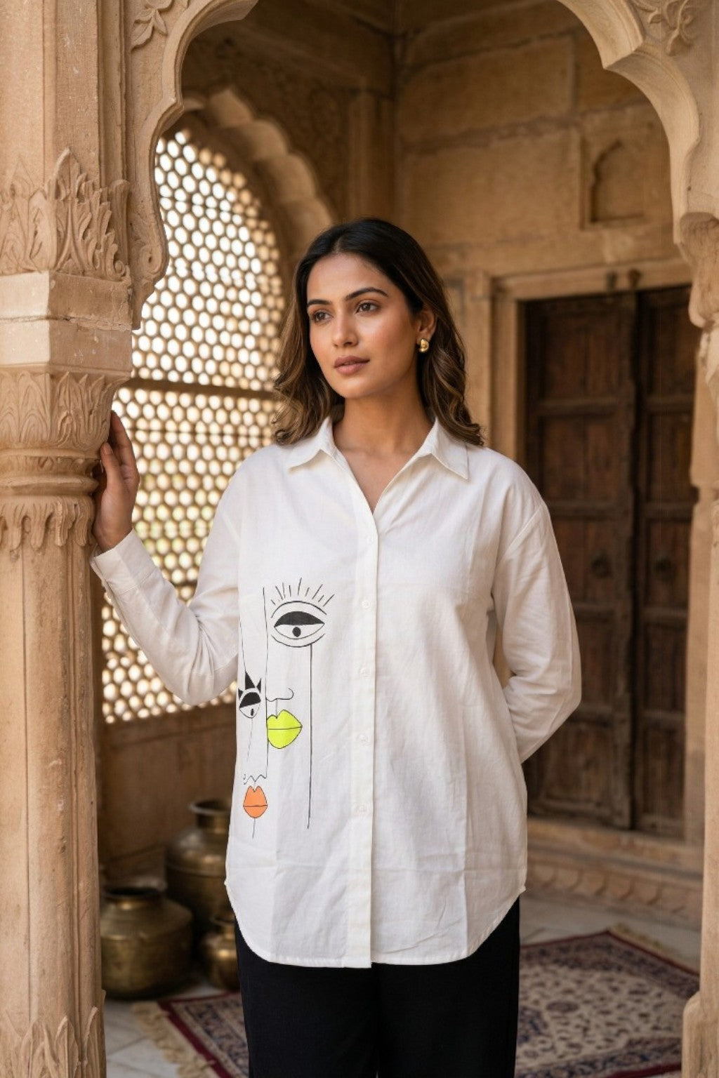 women wearing THE VIRAASAT HANDPAINTED SHIRT, a tribal inspired hand-painted cotton satin shirt from M R JAIPUR