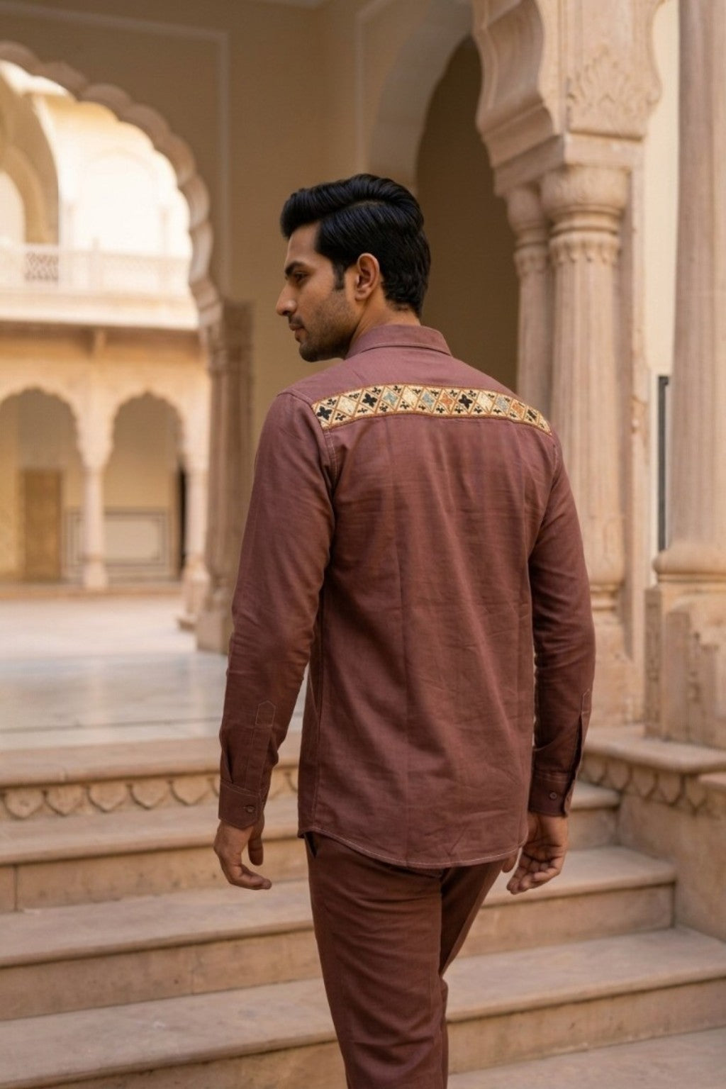 Man wearing JANTAR MOTIF MENS SHIRT, a brown hand-embroidered cotton-linen shirt from M R JAIPUR