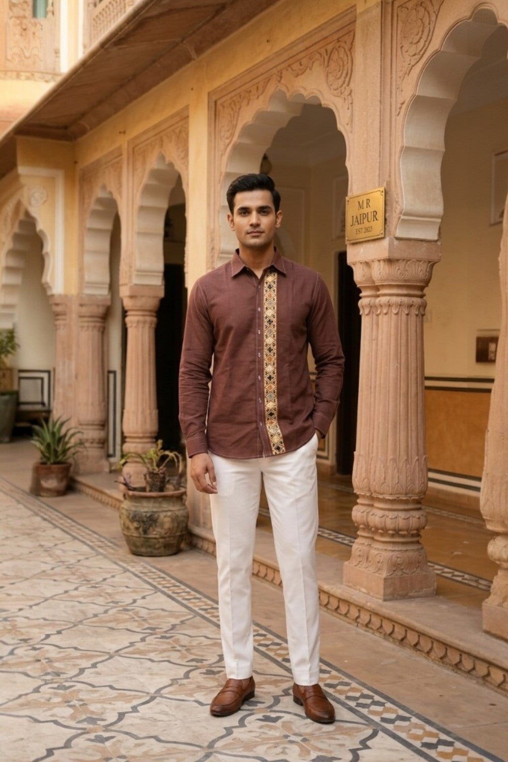 Man wearing JANTAR MOTIF MENS SHIRT, a brown hand-embroidered cotton-linen shirt from M R JAIPUR