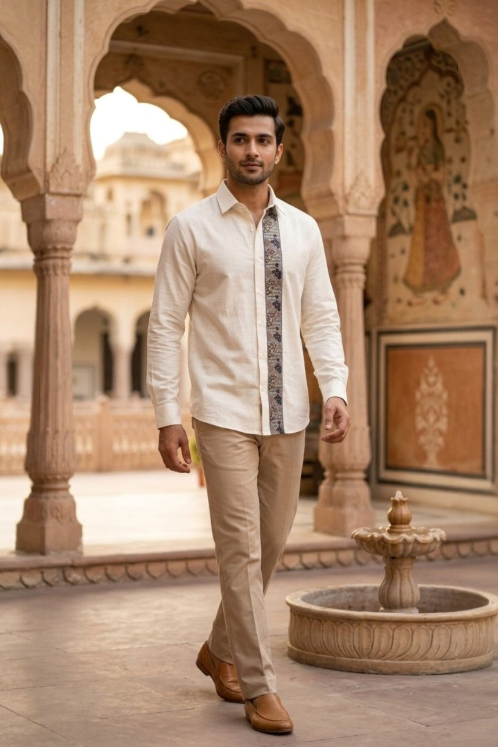 Man wearing JHAROKA ACCENT MENS SHIRT, a off white hand-embroidered cotton-linen shirt from M R JAIPUR