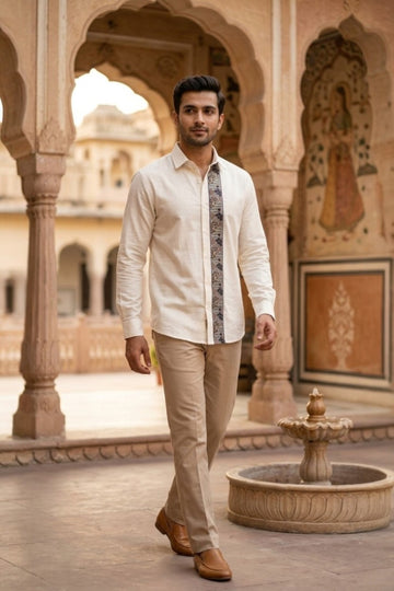 Man wearing JHAROKA ACCENT MENS SHIRT, a off white hand-embroidered cotton-linen shirt from M R JAIPUR
