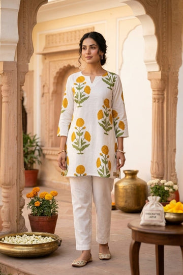 women wearing THE PALAASH BUTTI HANDBLOCK KURTI, a white floral inspired hand-block cotton kurti from M R JAIPUR